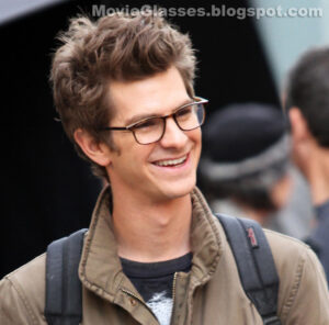 Andrew Garfield smiling and wearing Oliver Peoples eyewear on the set of The Amazing Spider-Man